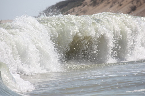 A large wave pounds the beach at Marconi Beach