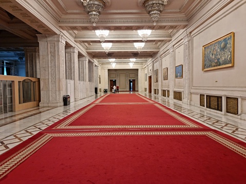 The Palace of the Parliament is the seat of the Parliament of Romania. The Palace of the Parliament is one of the heaviest buildings in the world, constructed over a period of 13 years (1984–1997). The image shows a large corridor inside the Parliament Building.