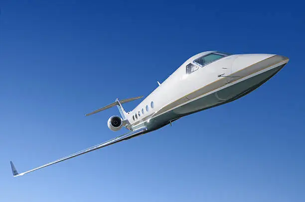 Gulfstreaam corporate jet isolated against blue sky
