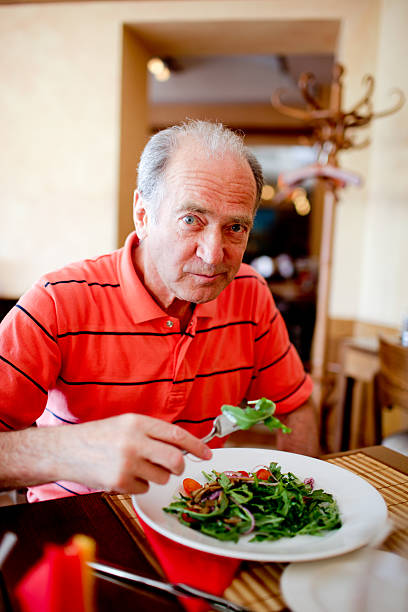 istock Senior man eating ruccola salad 157480847