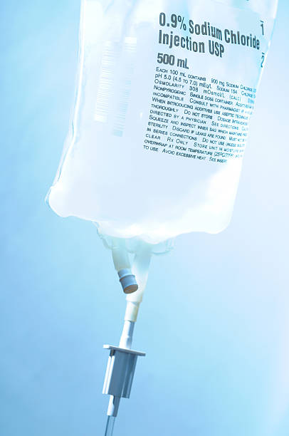 Intravenous IV bag bolus drip with sodium chloride Intravenous IV drip bag. saline drip stock pictures, royalty-free photos & images