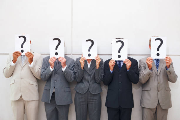 istock Some businessmen cover their faces with a question mark sign 157480958