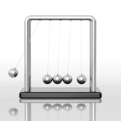 Newton's Cradle swinging on a reflective white background. Very high resolution 3D render.