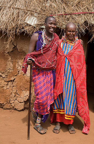 istock Young masai with old female relative outside her mud hut. 157481705