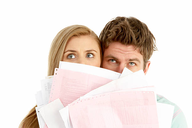 Couple Holding Stack Of Bills stock photo