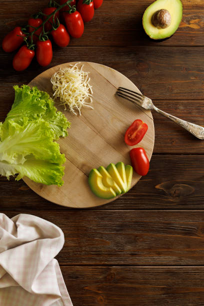 istock mockup Round cutting board on the table, served with vegetables 1574820923
