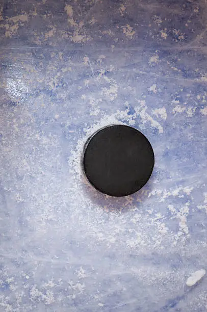 Hockey puck on the blue ice