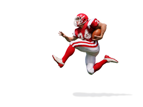 Football player running extremely fast with dynamic body language. File includes clipping path and drop shadow.