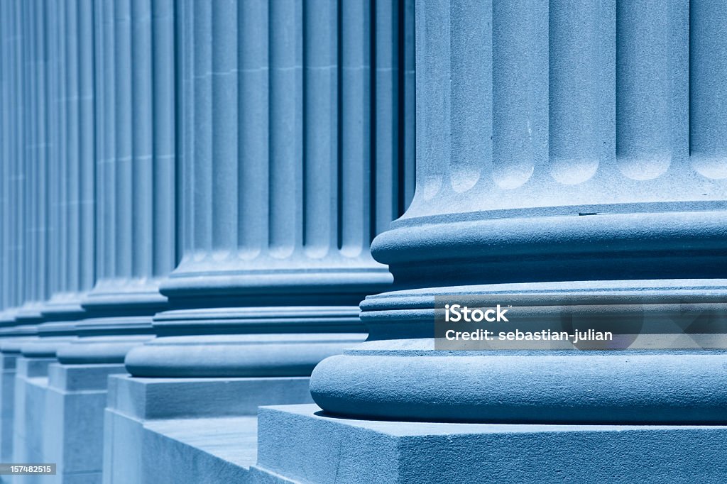 Diagonal view of large blue columns XXXL - wonderful columns in front of the new york city court house - blue filter treatment - shallow depth of field - focus at first column - camera canon 5D mark II - unsharped RAW - adobe colorspace Law Stock Photo