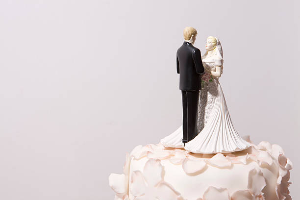 istock Bride and groom decorations on top of a wedding cake 157482535