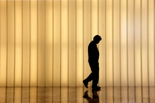 Abstract image of businessman walking down the corridor, 3D generated image.