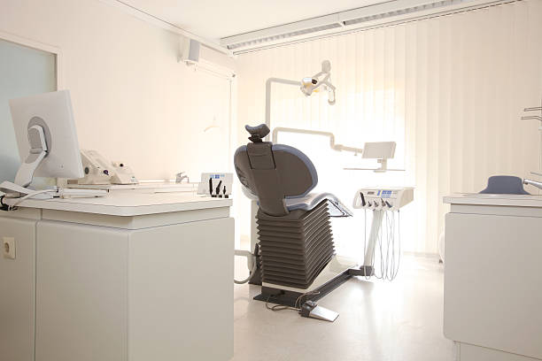 Dentist room, computer and treatment chair Dentist room, computer and treatment chair,  dental drill stock pictures, royalty-free photos & images