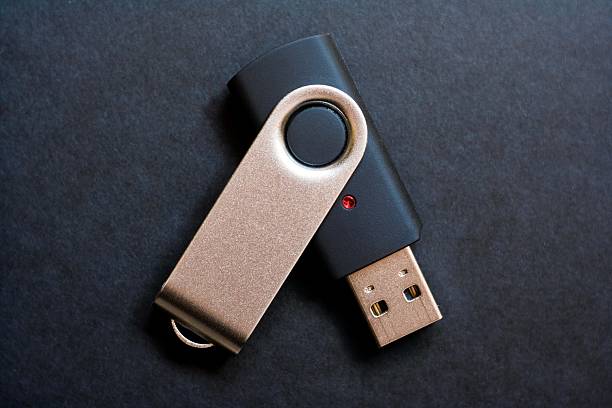 USB flash storage with red led on black background modern usb stick on black usb stick photos stock pictures, royalty-free photos & images