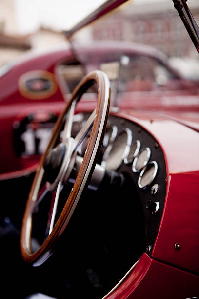 Close up of steering wheel on red classic car