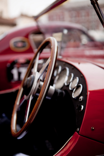 Close up of a wooden steering wheel on a classic car