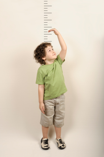 Little child measures his height