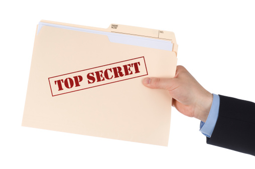 Businessman holding top secret documents.