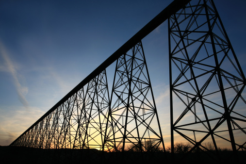 One of the largest trestle bridges in the world. Lethbridge, Alberta, Canada. This massive trestle bridge spans a huge distance over top of the Old Man River in Southwest Alberta, Canada. It was constructed over 100 years ago near Fort Whoop Up. Nobody is in the image, taken on the east side of the river from below the bridge. 