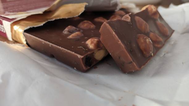 istock Chocolate bar for whole hazelnuts in foil 1574845676