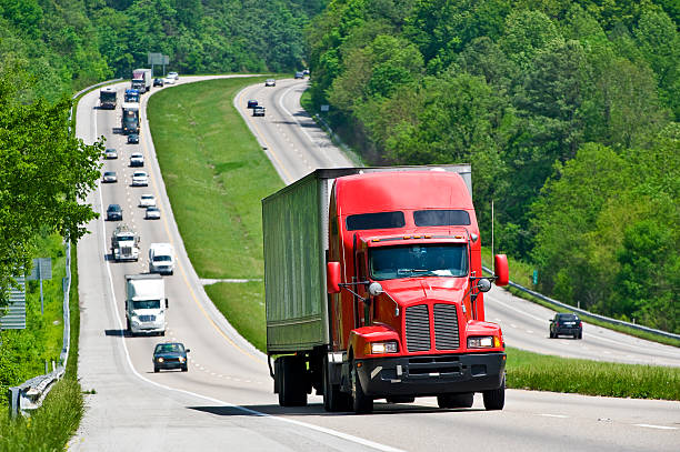 istock Red Semi Truck Climbing Hill On Interstate Highway 157484634
