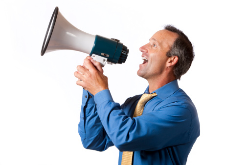 A 40-45 year old caucasian male making a happy announcement via megaphone. isolated on a white background.