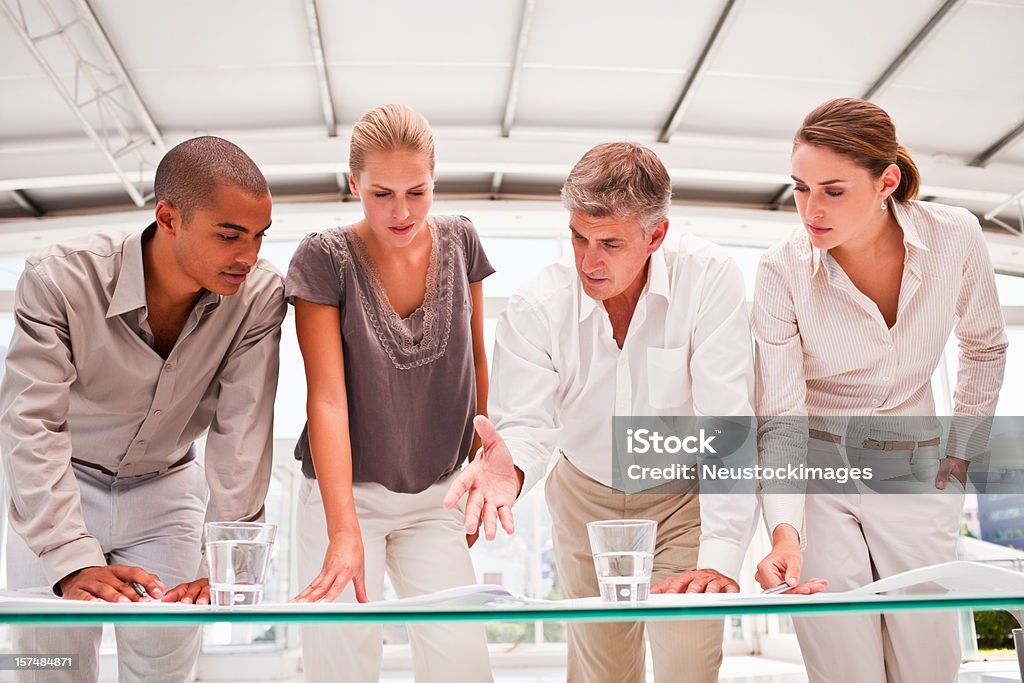 Business colleagues planning together in office Group of business colleagues planning together in office 20-24 Years Stock Photo