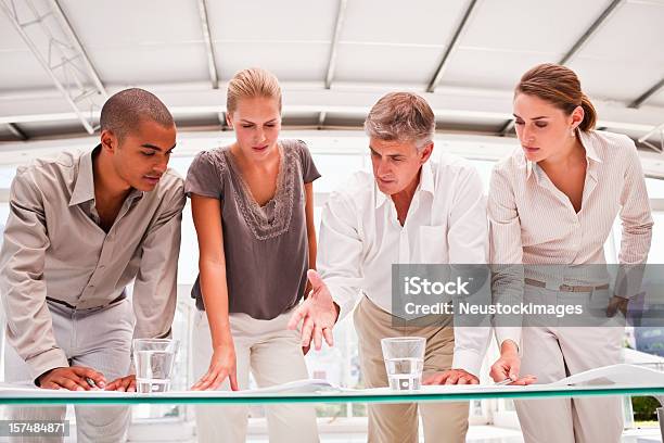 Business Colleagues Planning Together In Office Stock Photo - Download Image Now - 20-24 Years, 20-29 Years, Adult