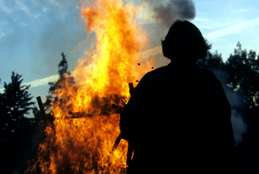 Man's silhouette in front of a cremation