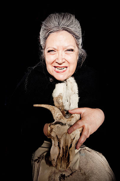 Bad Witch Voodoo Bad witch holding a animal skull laughing nasty, sending her voodoo power. Portrait. ugly old women stock pictures, royalty-free photos & images