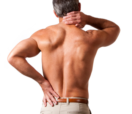 rear view of a shirtless 40-45 year old male holding his neck and lower back in pain.