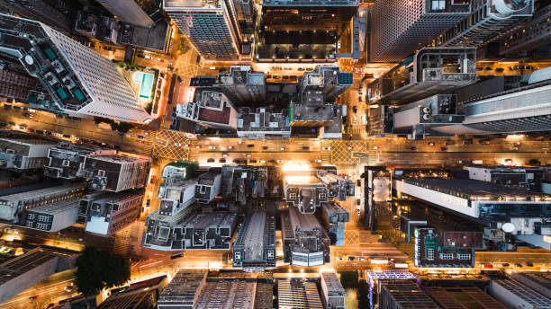 istock Car traffic transportation on road intersection, skyscraper buildings, condominiums in financial business or residential district at Hong Kong island. Drone aerial cityscape top view. Asia transport 1574862469