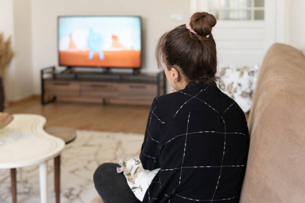 istock Girl watching cartoons. 1574891853