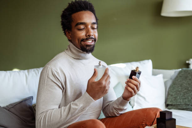 istock Young Man Embraces the Delight of Perfume 1574935948