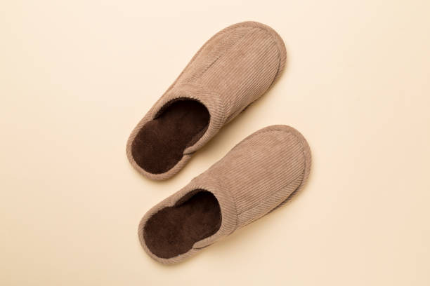 istock Man's slippers on color background, top view 1574941800