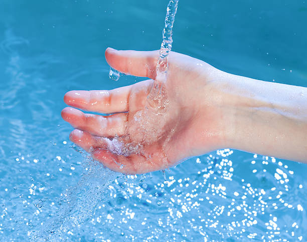 istock kid's hand under stream of water 157495040