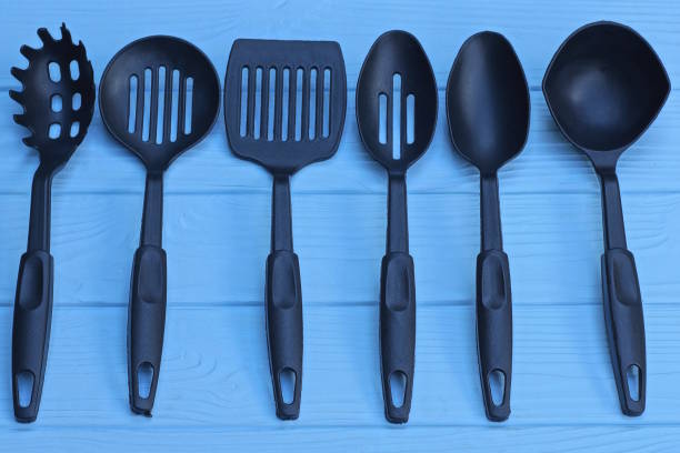 a set of six black plastic kitchen utensils