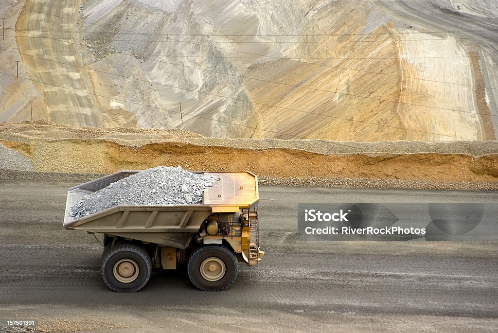 Yellow large dump truck in Utah copper mine seen from above large dumptruck in utah copper mine Mining - Natural Resources Stock Photo