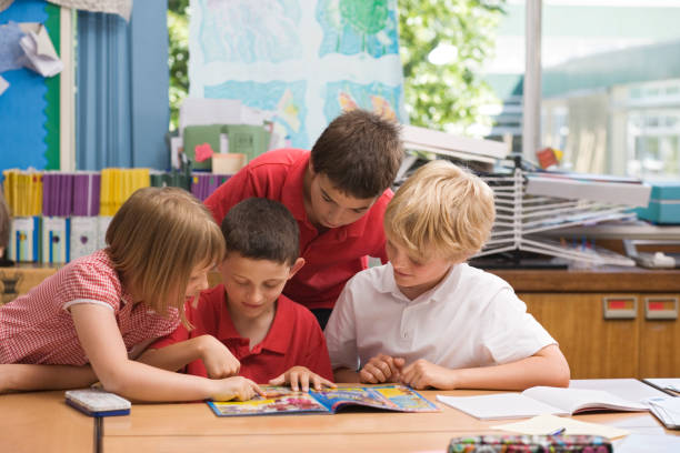 Children reading a comic in school  reading comic book stock pictures, royalty-free photos & images