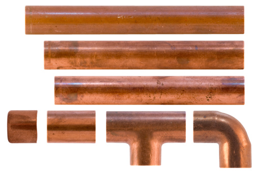 Copper water pipe fittings for soldering plumbing concept or repair water supply on vintage wooden boards