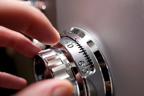 Hand opening a safe. stock photo