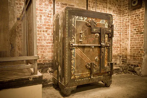 An antique safe at a grungy place.