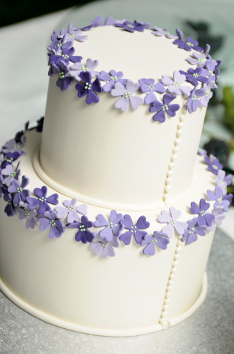 Beautiful simple wedding cake with icing flowers shot with shallow depth of field