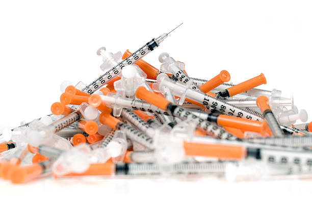 istock Pile of used syringes on white 157502311