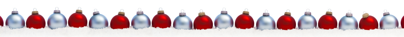 Christmas background composition with Christmas baubles on white snow.