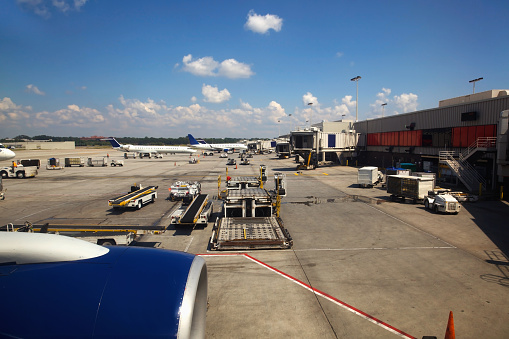 Madrid, Spain – June 26, 2021: Madrid Bajaras, June 26, 2021: Long zoom view of airplanes on tarmac and iconic roof of Bajaras Airport in Madrid, Spain