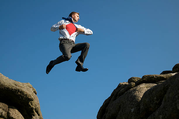 istock Superhero Businessman Leaps into the Sky 157502646
