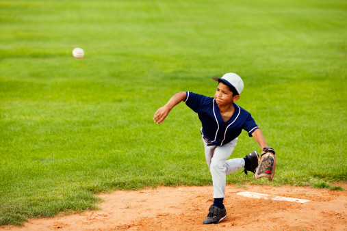 A youth league pitcher delivers to the plate. Fastball, you're out.