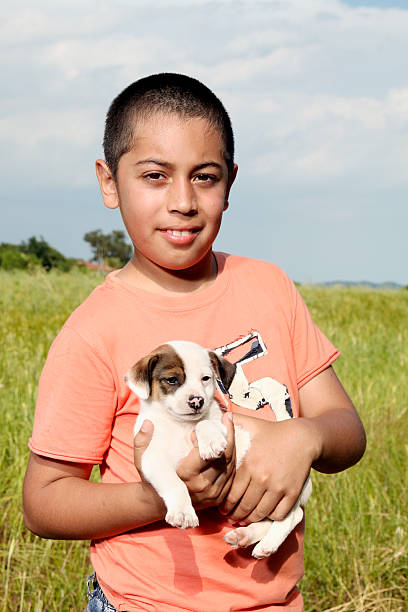 Elementary age boy withy his puppy.