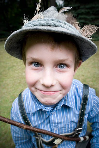 istock Young boy dressed as hunter, wearing felt hat, bow, lederhosen 157502764