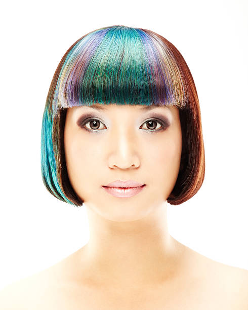 A young woman is looking at the camera.  Vertically framed shot.